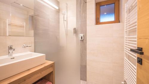 a bathroom with a sink and a shower at Central Hotel & Apart mit Landhaus Central in Fügen