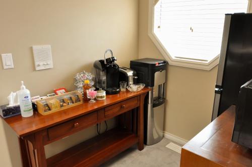a kitchen with a table with a coffee maker at Cornerstone Bed and Breakfast in Revelstoke