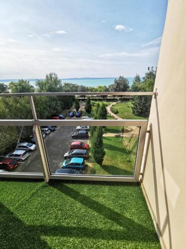 a balcony with cars parked in a parking lot at Szín-Aranyhíd Apartman in Siófok