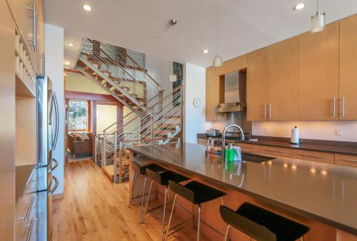 a kitchen with a counter and a staircase at Columbia River Gorge View FOUR Condo in Hood River