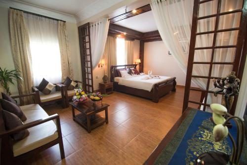 a living room with a bed and a ladder at Angkor Pearl Hotel in Siem Reap