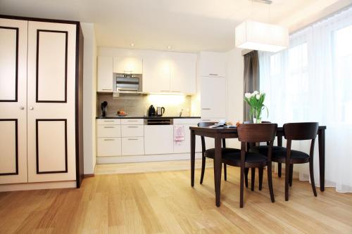 a kitchen with a table and chairs in a room at CITY STAY - Kieselgasse in Zürich