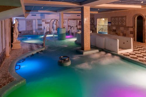 a pool in a hotel with a water slide at Hotel Comendador in Carranque