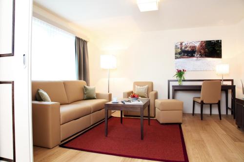 a living room with a couch and a table at CITY STAY - Kieselgasse in Zürich