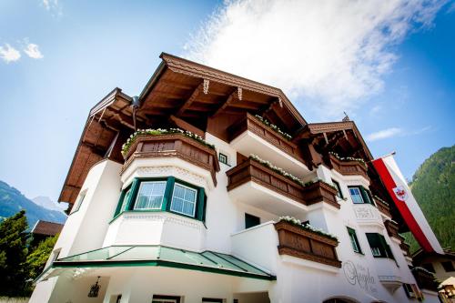 a building with wooden balconies on top of it at Villa Angela in Mayrhofen