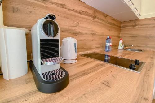 a toaster sitting on a kitchen counter next to a sink at Peter's Market apartment in Liepāja