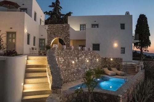 una villa con piscina di fronte a una casa di AnamneZia Luxury Suites a Città di Kos