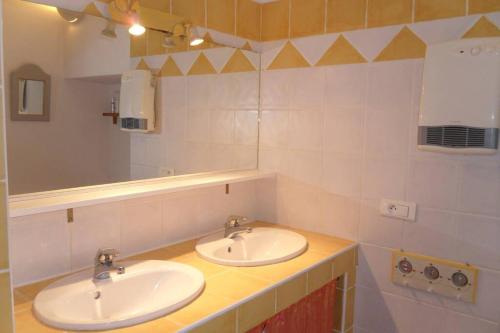 een badkamer met 2 wastafels en een spiegel bij Maison au centre de St Jean du Gard in Saint-Jean-du-Gard