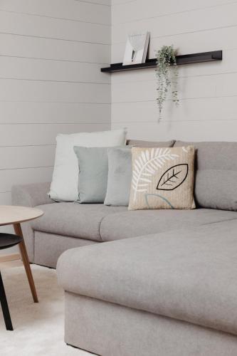 a couch with a pillow on it in a living room at mei chalet - DAS BARBARA in Leutasch