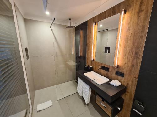 
a bath room with a shower and a sink at DAS KEHRS - Hotel auf dem Petersberg in Erfurt
