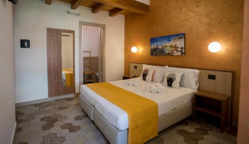a bedroom with a large bed in a room at Alterego B&B in Milazzo