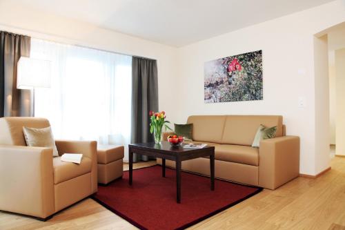 a living room with two couches and a table at CITY STAY - Kieselgasse in Zürich