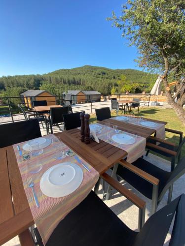 a wooden table with plates on it on a patio at Kairos Hotel in Kas