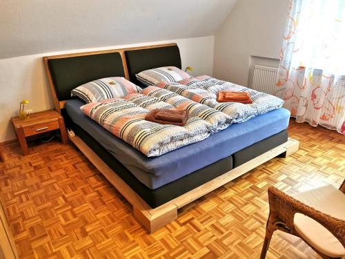 a bedroom with a bed with a blue mattress at Landhaus Lüneburger Heide "Ferienhaus bis 6 Personen" in Neuenkirchen