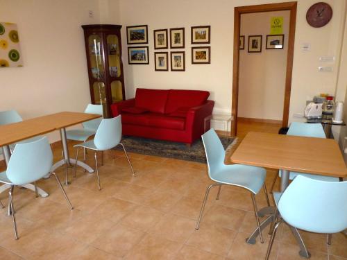 a living room with tables and a red couch at B&B & Residence Pozzo Misseo in Matera