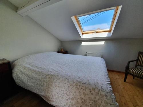 a bedroom with a bed and a window at Le Maissin 1876 in Paliseul