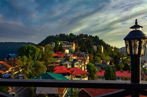 a street light in front of a town with a mountain at Sumitel Vista 800m from Mall Road in Darjeeling