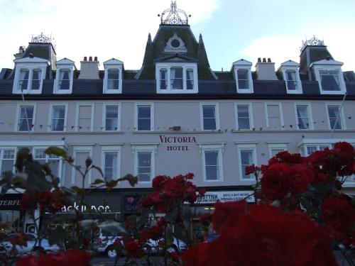a large white building with a roof at The Victoria Hotel in Rothesay