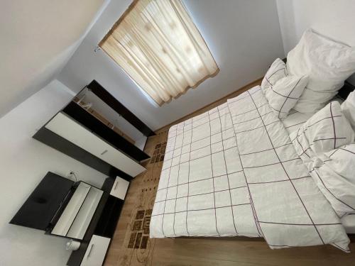 a large white bed in a room with a window at Casa Wiesmann Băile Felix in Baile Felix