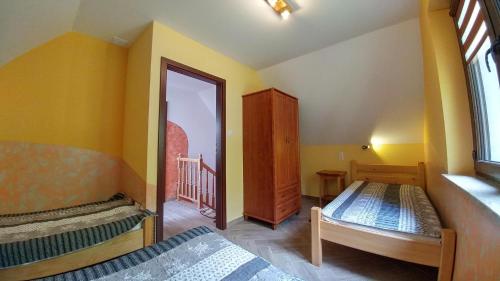 a bedroom with two beds and a window at Cypla Czar in Polańczyk