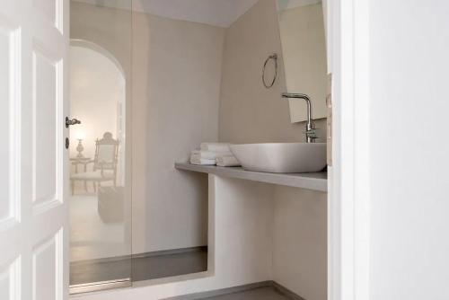 a bathroom with a sink and a mirror at Casasantantonio 18th Century Luxury Mansion in Fira