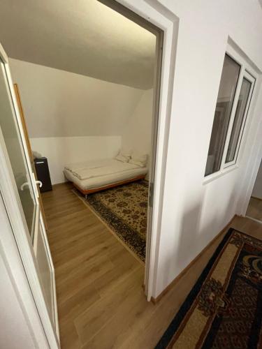 a hallway with a door leading to a room with a bed at Casa Wiesmann Băile Felix in Baile Felix