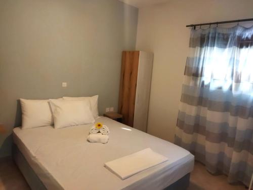 a bedroom with a bed with a stuffed animal on it at Pefkonas apartments2 100 m from the beach in Psakoudia