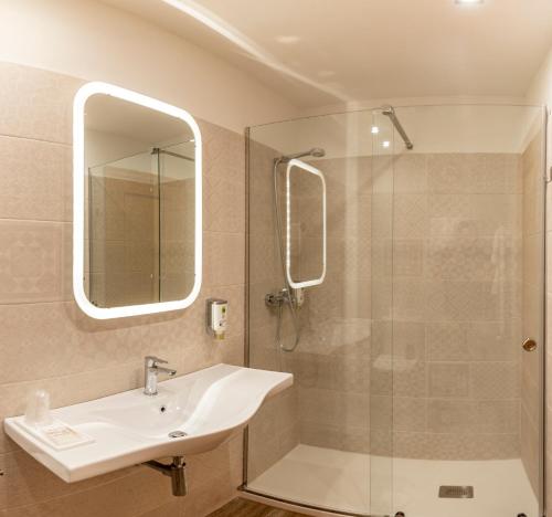 a bathroom with a sink and a shower at Hotel Santa Cruz in Cangas de Onís