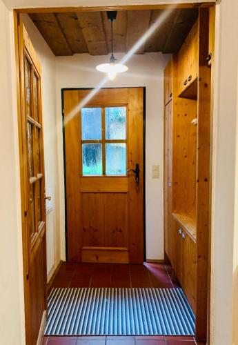 a hallway with a wooden door and a window at PinkDeer in Hallstatt