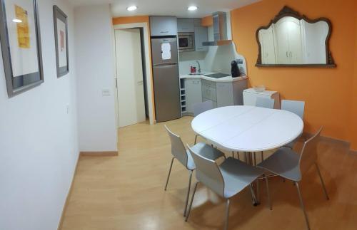 a small kitchen with a white table and chairs at EVA & TRAVEL - Cal Manco in Ulldemolins