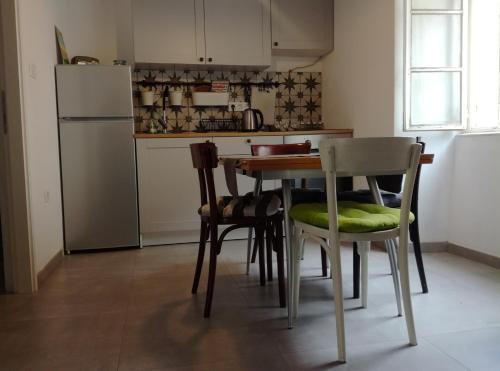a kitchen with a table and chairs and a refrigerator at Apartment Mila Krk in Krk