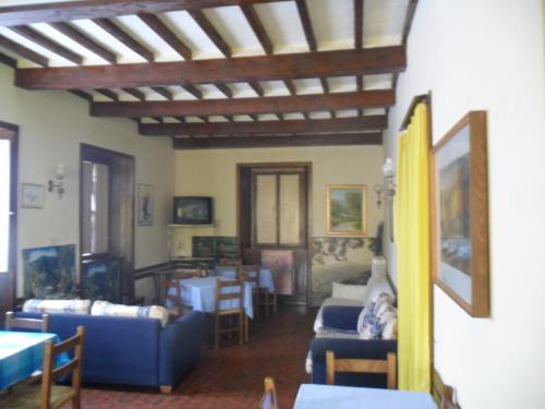 a living room filled with furniture and a tv at Albergo Giardino in Badia Prataglia