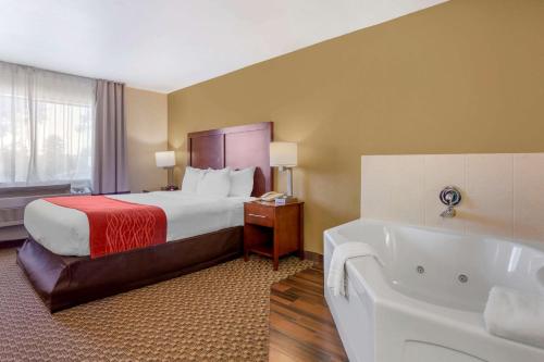 a hotel room with a bed and a bath tub at Comfort Inn Payson in Payson
