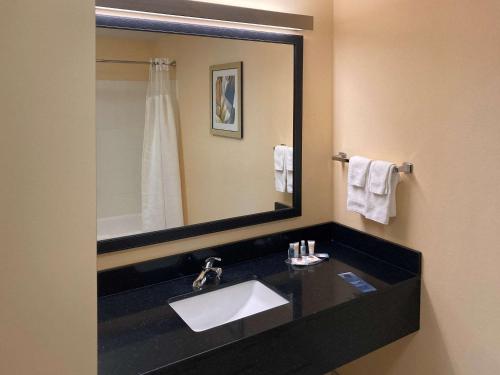 a bathroom with a sink and a large mirror at Comfort Inn & Suites Ankeny - Des Moines in Ankeny