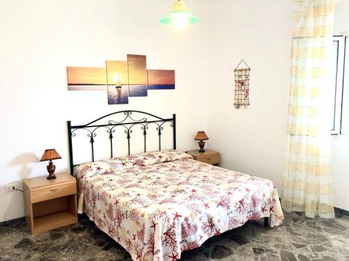 a bedroom with a bed and two night stands at Sunset Salentorelax San Gregorio in Marina San Gregorio