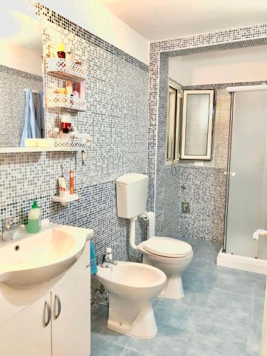 a bathroom with a toilet and a sink at Sunset Salentorelax San Gregorio in Marina San Gregorio