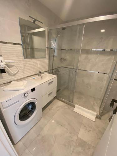 a bathroom with a washing machine and a shower at Viva Suites Cappadocia in Nevşehir