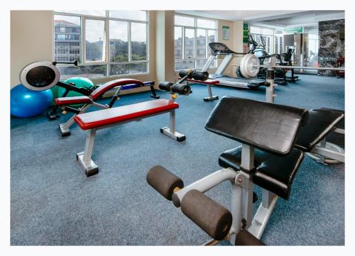 a gym with several different types of equipment in a room at Holiday Inn Dar Es Salaam by IHG in Dar es Salaam