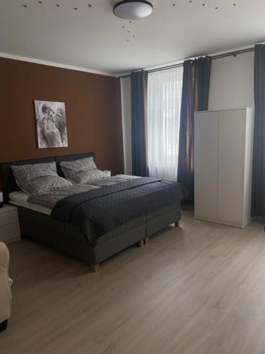 a bedroom with a bed and a large window at Ferienwohnung mit Terrasse in Aue