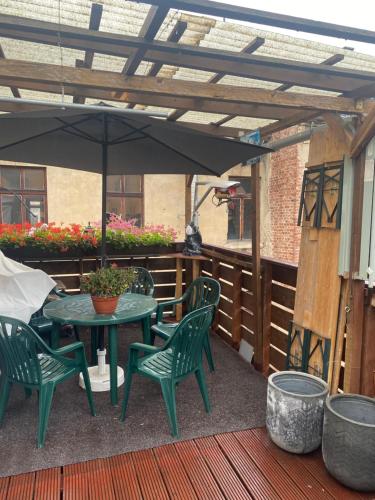a patio with a table and chairs and an umbrella at Ferienwohnung mit Terrasse in Aue