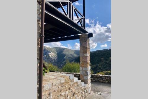 a view from a building with mountains in the background at Periklis Guesthouse Anavriti. in Sparti