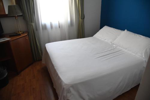 a white bed in a room with a window at HOTEL DUCA D'AOSTA in Mogliano Veneto