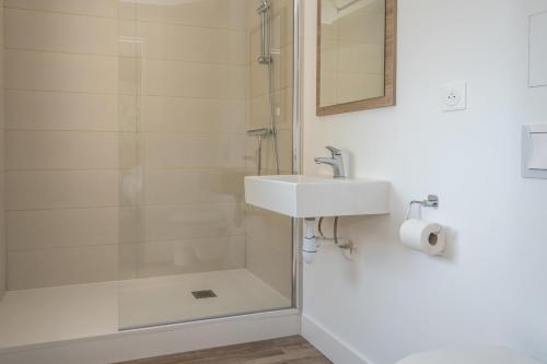 a bathroom with a sink and a shower at KYRIAD DIRECT TOULON OUEST - La Seyne sur Mer in La Seyne-sur-Mer