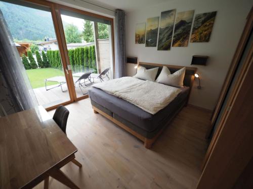 a bedroom with a bed and a large window at Loferama Top 1 in Lofer