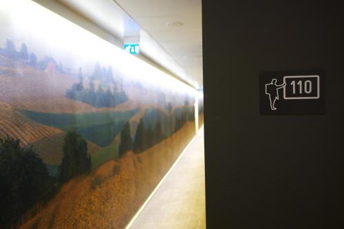 a hallway with a painting on the wall at Comfort Hotel City in Gothenburg