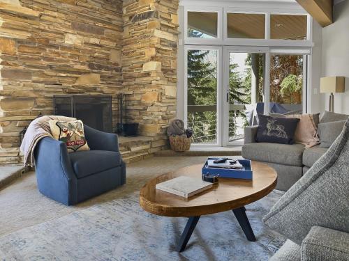 a living room with two couches and a stone wall at B11 Powder Run condo in Park City