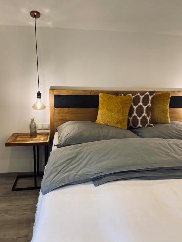 a bedroom with two beds and a table with a lamp at Apartments Riese in Neustift im Stubaital