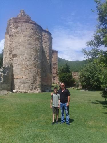 a man and a boy standing in front of a castle at My home udabno in Udabno