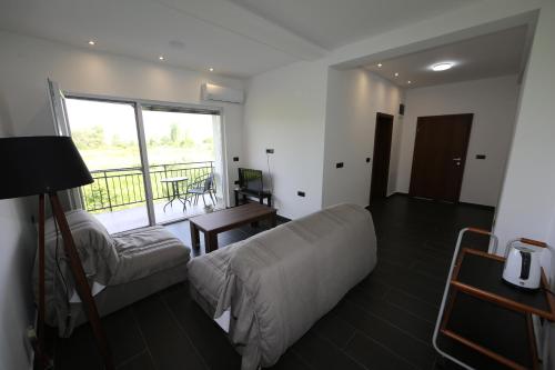 Una sala de estar con un sofá y un balcón. en Villa Goriza Prestige, en Ohrid