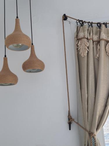 a curtain hanging on a wall with two lights at Tramonto Luxury Villa No1- Breathtaking sunset view in Karpathos Town